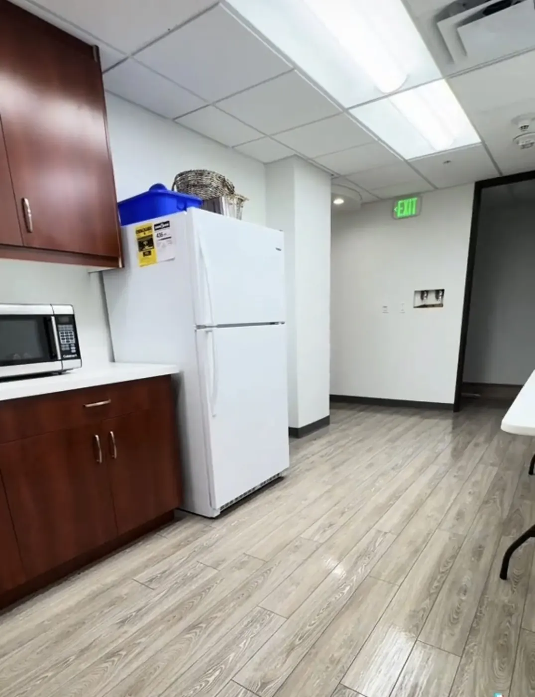 Office break room with clean counters and freshly mopped floor