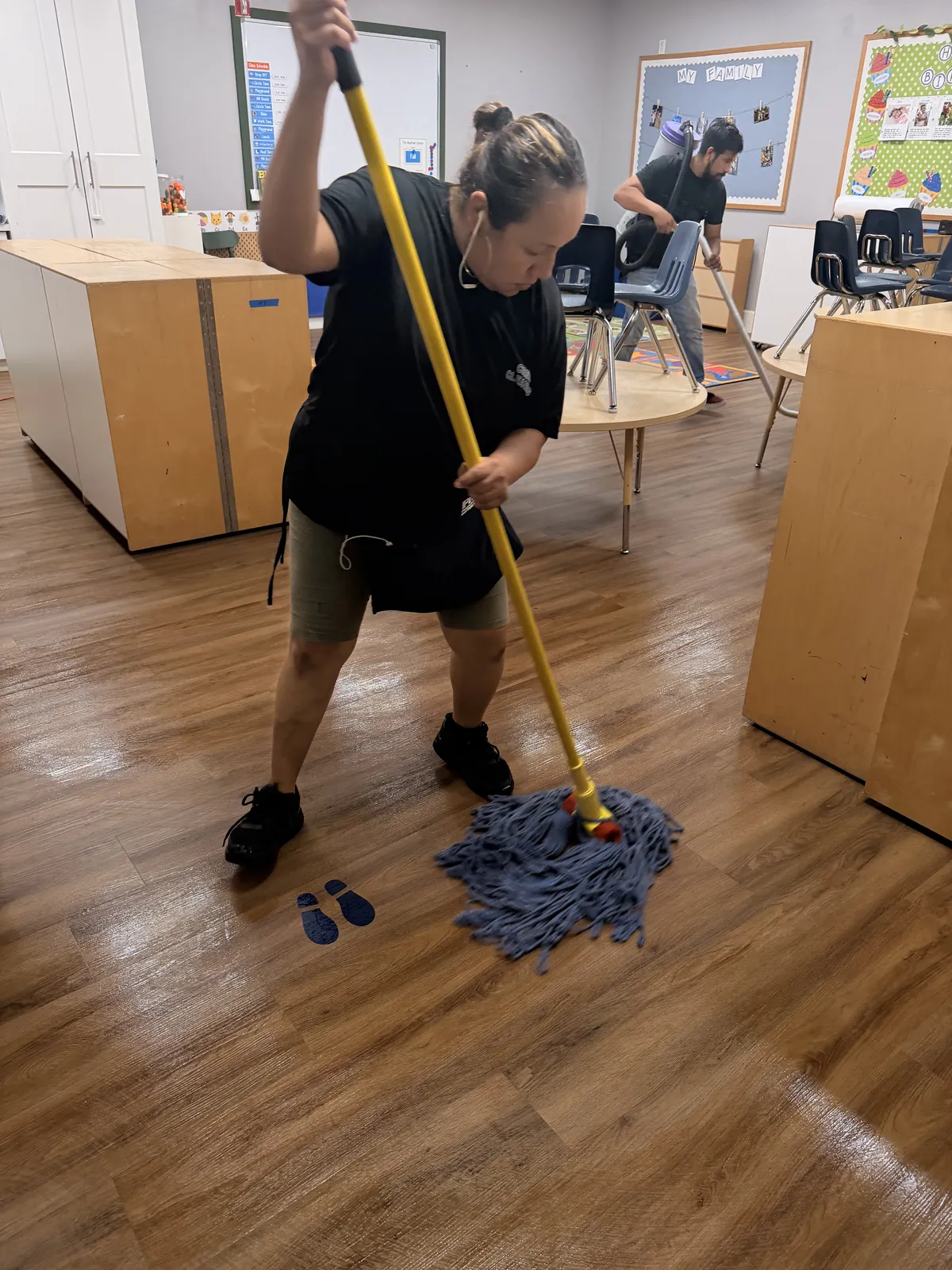 One of our team mopping a classroom floor after hours
