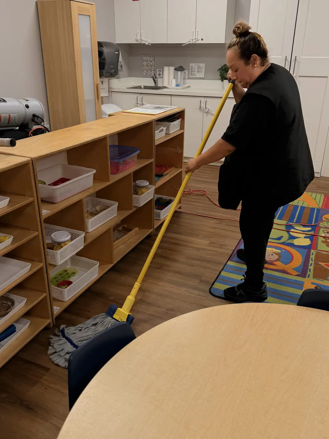 Our cleaner mopping a wood-look floor after hours
