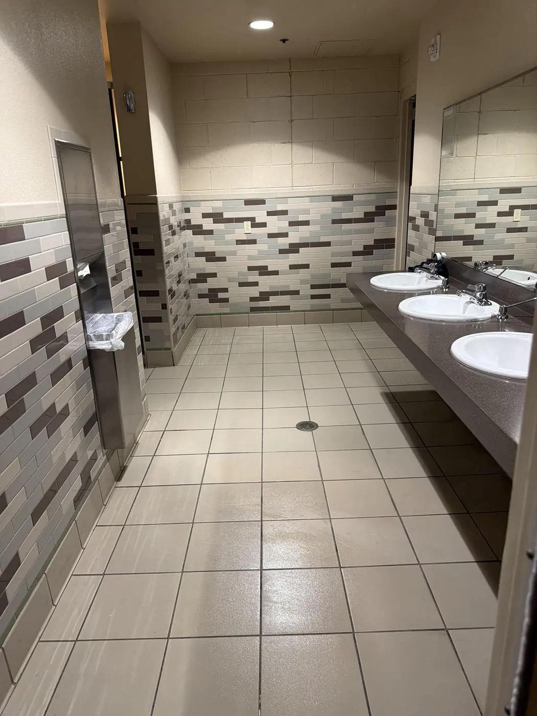 Commercial restroom sinks and tile floor after an after-hours cleaning